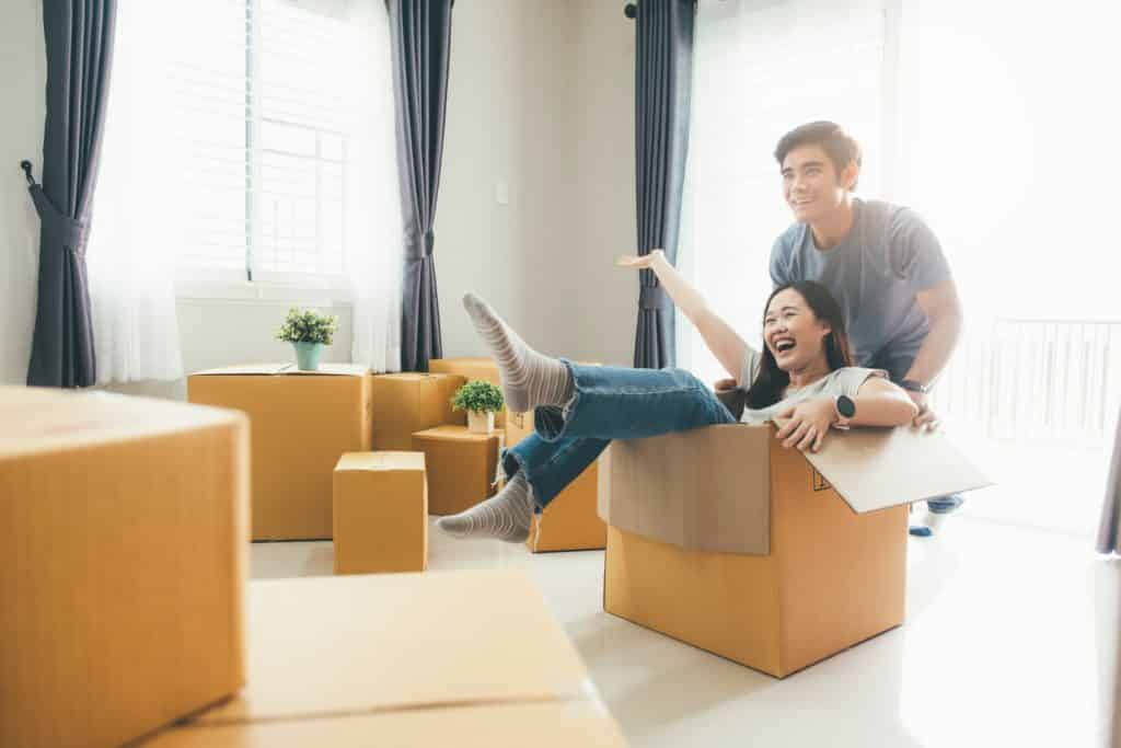 happy young couple enjoying together moving in a new house.